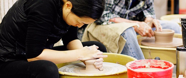 Students making pottery on the wheel