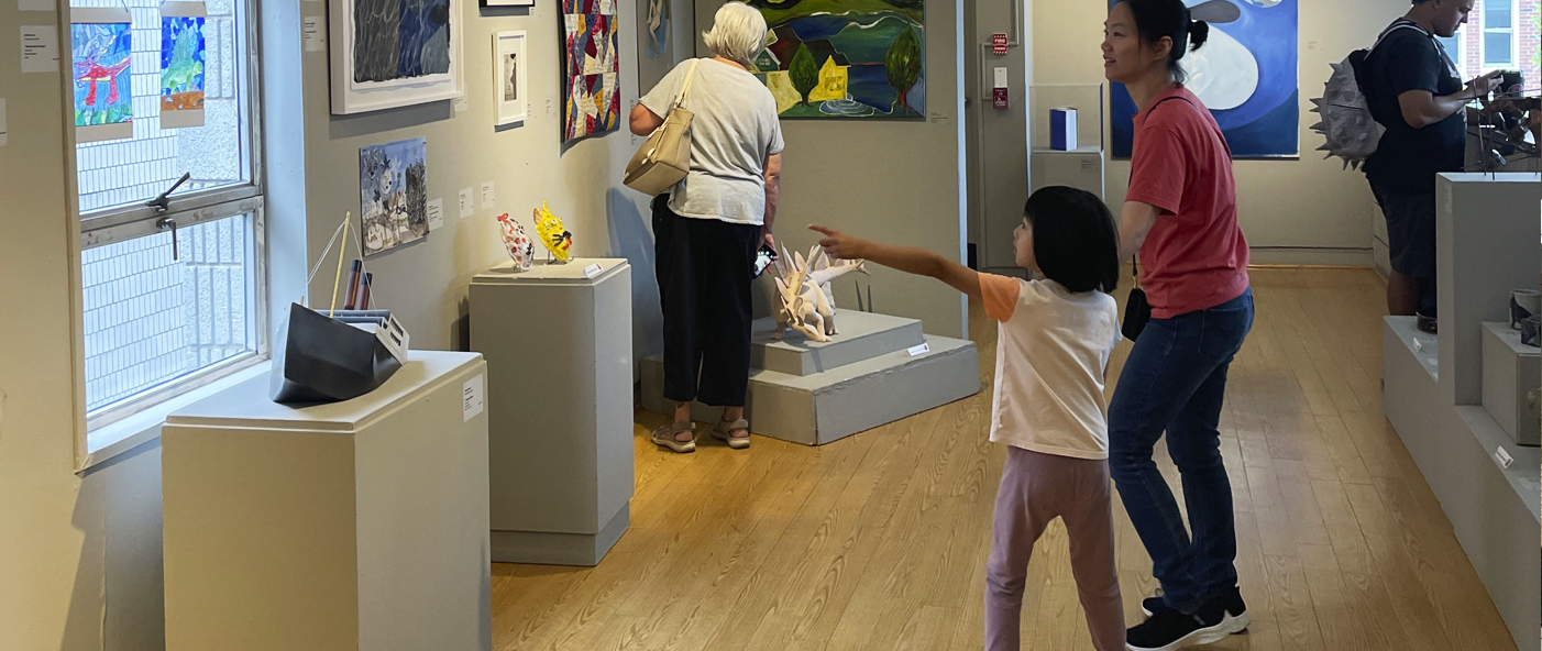 little girl pointing at artwork